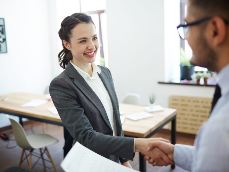 Congrats Successful man and woman greeting one another after making deal