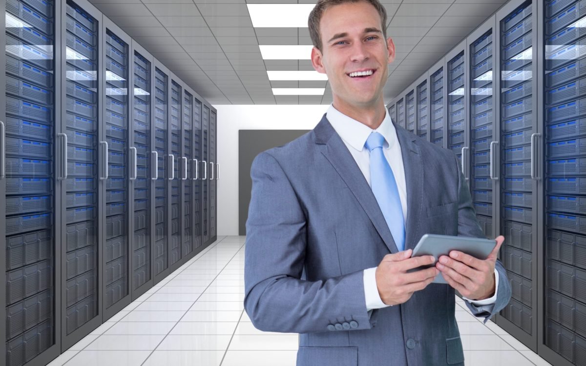 Digital composite image of businessman using digital tablet in server room