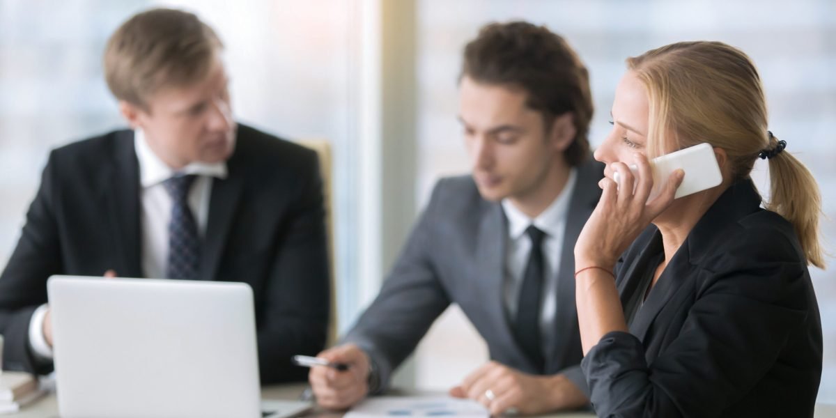 Businesswoman making call, attending business meeting. Group of colleagues or subordinates partaking in powerful training activities, moving online marketing to the next level, important phone talk